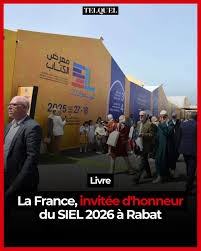 a group of people walking in front of a yellow wall